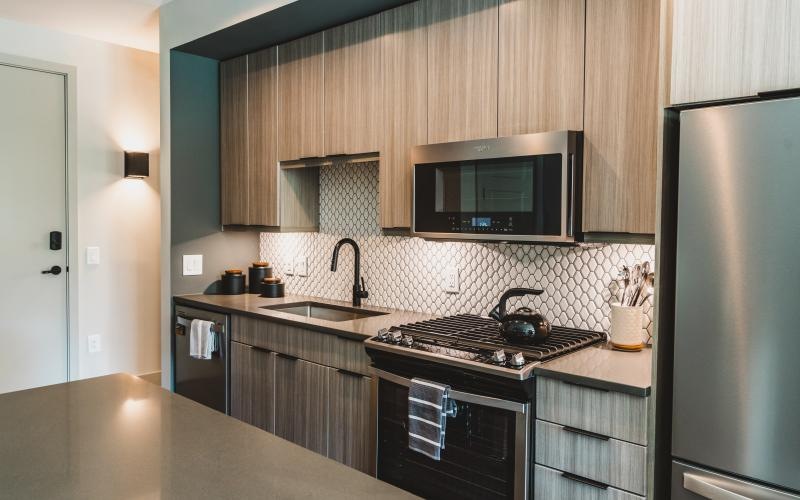 a kitchen with a stove and microwave